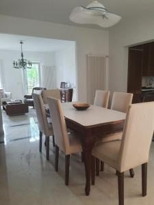 a dining table and chairs in a living room at Casa Ponente in Sanremo +14 photos