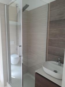 a bathroom with a sink and a shower with a toilet at Casa Ponente in Sanremo