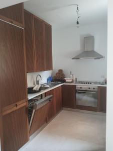 a kitchen with wooden cabinets and a stove top oven at Casa Ponente in Sanremo