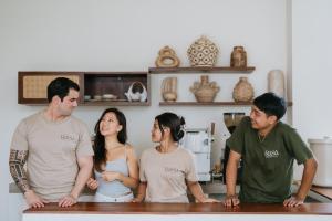 a group of people standing around a table in a kitchen at Rasa Ubud Yoga Coliving in Ubud +32 photos