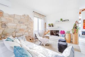a living room with a white couch and a stone wall at Villa Gatti Marina di Pietrasanta in Marina di Pietrasanta +83 photos
