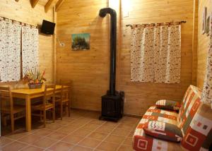 a stove in a room with a table and a dining room at Apartamentos Paraje San Gines in Andújar