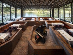 a restaurant with tables and a piano in the middle at The Prince Karuizawa in Karuizawa +41 photos