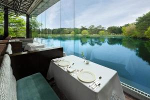 a table and chairs with a view of a lake at The Prince Karuizawa in Karuizawa