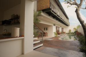 an external view of a house with a swimming pool at Rasa Ubud Yoga Coliving in Ubud