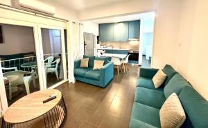 a living room with a green couch and a table at Mediterranean Blue - Secret Escape in Limassol