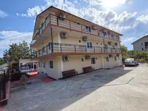 a building with benches in a parking lot at Sea Breeze Costinești in Costinesti +34 photos