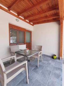 a dining room with a table and chairs at Daniela Apartments in Nea Roda