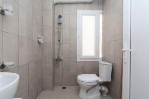 a bathroom with a toilet and a shower and a sink at Blue Life Hotel in Konak