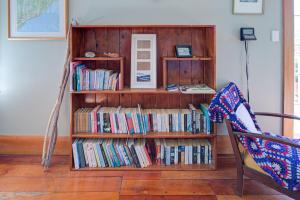 a book shelf filled with lots of books at Te Kōpuha in Tora