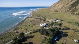 an aerial view of a beach and the ocean at Te Kōpuha in Tora