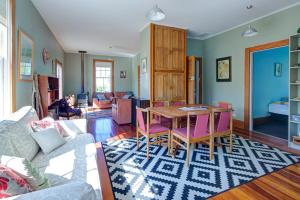a living room with a table and a couch at Te Kōpuha in Tora