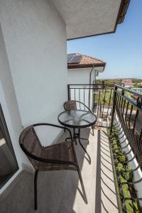 a balcony with a table and chair on a building at Vila Amir Vama Veche in Vama Veche +54 photos