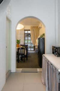 an archway leading into a dining room with a table at Nap Boriphat in Bangkok +28 photos