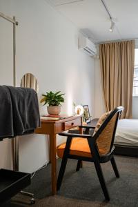 a room with a desk and a chair and a bed at Nap Boriphat in Bangkok