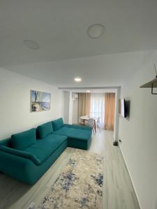 a living room with a blue couch and a table at Olimp sea view apartments - 802 in Olimp