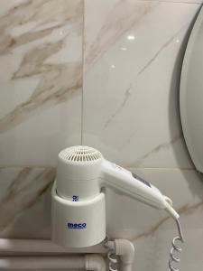 a close up of a hair dryer in a bathroom at Olimp sea view apartments - 802 in Olimp +15 photos