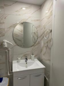 a bathroom with a sink and a mirror at Olimp sea view apartments - 802 in Olimp
