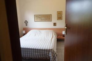 a bedroom with a bed with a blanket on it at Bella Casa in Alexandroupoli