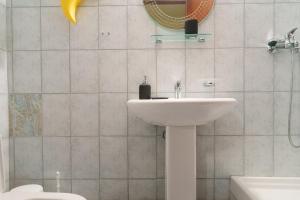 a bathroom with a sink and a mirror and a toilet at Bella Casa in Alexandroupoli +35 photos