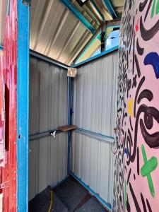 an empty garage with graffiti on the wall at Redang Campstay A Frame in Redang Island