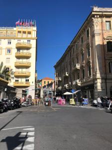 a city street with a building with flags on it at NONSOLOMARE wifi aria condizionata Parcheggio in Sanremo