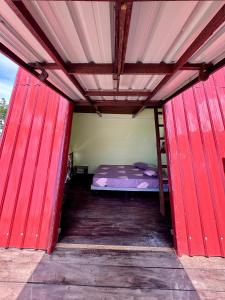 a red room with a bed inside of it at Redang Campstay A Frame in Redang Island