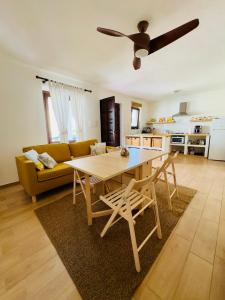 a living room with a table and a yellow couch at Casa Lulù in Cala Gonone
