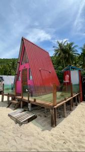 a small house with a red roof on the beach at Redang Campstay A Frame in Redang Island