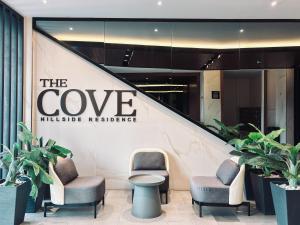 a lobby with chairs and a sign that reads the cove nursing residence at The Cove Hillside Residence Ipoh by PLY Home in Ipoh