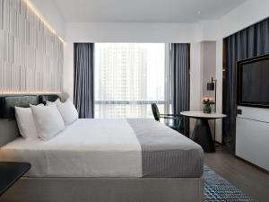Postel nebo postele na pokoji v ubytování Huizhou Zhongkai Hi-Tech Zone Meihua Hotel