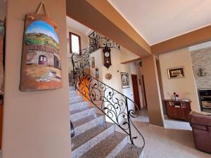 a staircase in a house with a painting on the wall at Villa Domenico in Zafferana Etnea