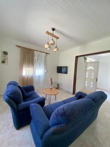a living room with two blue couches and a table at Alexas Apartment in Myrina