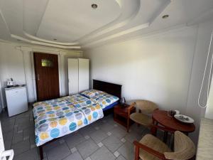 a bedroom with a bed and a table and chairs at POMERANIA Pokoje U Oliwii in Rewal