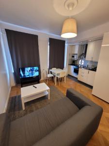 a living room with a couch and a table at Home Inn Rör11 in Stockholm +48 photos