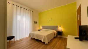 Postel nebo postele na pokoji v ubytování L'arancio B&B