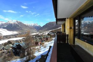 a balcony with a view of snow covered mountains at Vista Livigno - Happy Rentals in Livigno