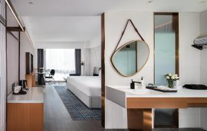 Postel nebo postele na pokoji v ubytování Huizhou Zhongkai Hi-Tech Zone Meihua Hotel