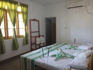 a room with two beds and a window at Thirumalai Park in Nilaveli