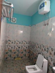 a bathroom with a toilet and a shower at Hilltop Heaven - One Bedroom Apartment in Mussoorie