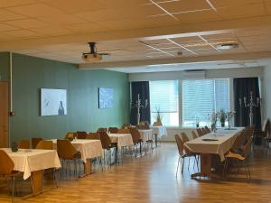 a dining room with tables and chairs in it at Suldal Hotell in Sand