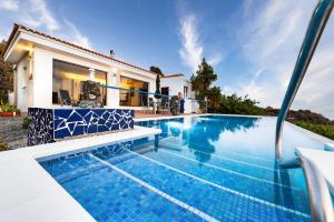 a swimming pool in front of a villa at Finca Stemann in Guía de Isora