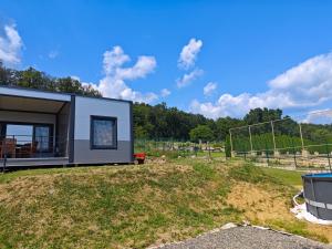 a tiny house sitting on top of a field at Chatka Katka in Klokočov