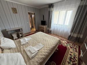Postel nebo postele na pokoji v ubytování Guest House Ugra