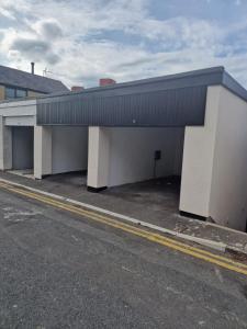 an empty parking lot next to a building at Town Center Duplex 6 in Harrogate