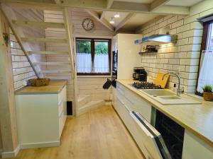 a kitchen with a sink and a counter top at Dom Wakacyjny Zielone Wzgórze in Mielno