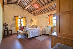 een slaapkamer met een bed en een stoel in een kamer bij Villa Angela e Giovanni in Vižinada