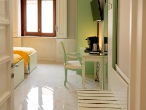 a room with a desk and a chair and a bed at Top Central Rooms in Caserta