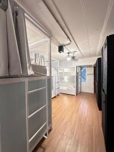 a room with white cabinets and a hard wood floor at Salee Hostel in Chiang Mai