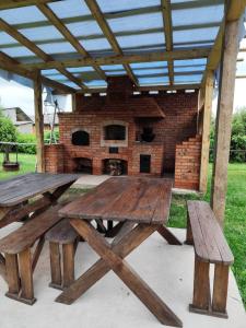 a picnic table and benches in front of a brick oven at садиба ТУГАН-ДВІР in Svityazʼ +29 photos